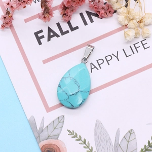 Detail of faceted drop-shaped blue turquoise pendant with a silver metal clasp