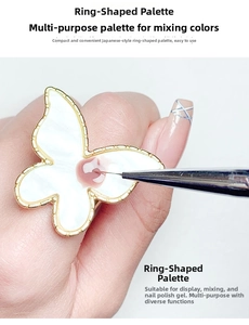 Close-up of butterfly-shaped gold-rimmed ring palette for nail art and color mixing