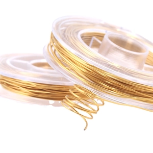 Spool of golden stainless steel jewelry wire with a spiral flexible metal texture