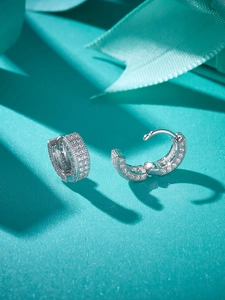 Macro shot of 925 sterling silver hoop earrings with pavé set moissanite stones