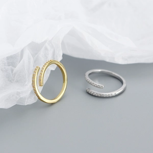 Detail of 925 silver minimalist open rings in gold and silver finish with zircon inlay