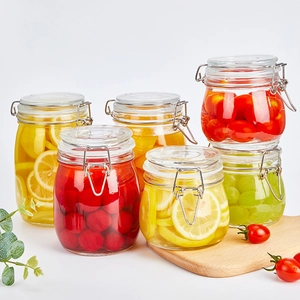 Set of clear glass storage jars with airtight metal clamps for food and honey storage