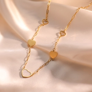 Elegant 18k gold plated heart necklace with shell inlay on soft champagne silk fabric