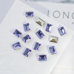 Macro view of purple K9 crystal rhinestones with pointed back and facet cuts