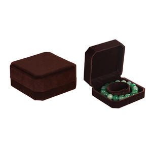 Detail of dark brown velvet jewelry box showing closed and open views with bead bracelet