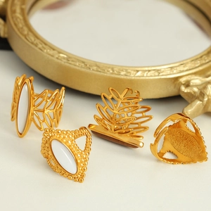 Vintage bohemian gold tiger eye rings with leaf designs and white oval stone inlays