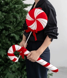 Detail of oversized red and white velvet candy cane and lollipop Christmas ornaments