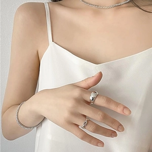 Minimalist silver set featuring smooth arc rings and zircon tennis necklace on model