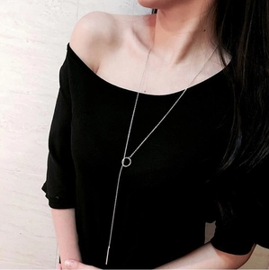 Silver Y-shaped necklace with circular buckle and bar pendant shown on model