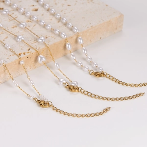 Chic gold chain necklace with heart and oval pearls featuring secure lobster clasp closure