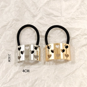 Close-up of hollow heart metal buckle on elastic hair ties showing 4cm by 2.5cm size