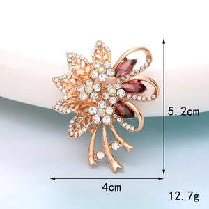 Detailed size view of a 5.2x4cm golden flower brooch with purple gemstones and crystals