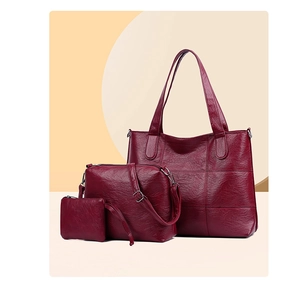 Three-piece burgundy tote set featuring textured grain leather and grid stitching details