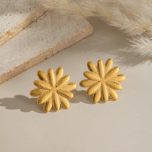 Vintage style gold flower stainless steel earrings with textured petals on a stone base