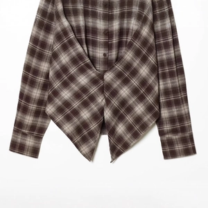 Brown plaid long sleeve shirt featuring a unique asymmetric split hem and cotton texture