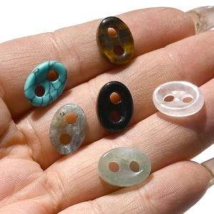 Close-up of assorted natural crystal and tiger eye pig nose buckles for DIY jewelry