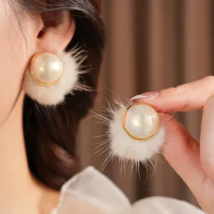 Elegant vintage winter earrings with white pom poms and pearls in gold setting