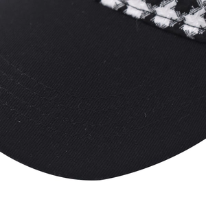 Detail view showing thickened houndstooth fabric and reinforced stitching on baseball cap brim