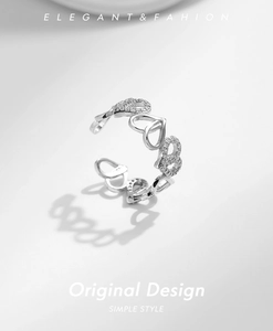 Macro detail of S925 silver heart-shaped ring with pavé-set sparkling cubic zirconia