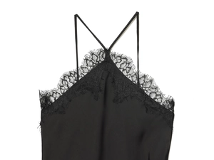 Detail of black silk camisole featuring delicate eyelash lace trim and thin criss-cross straps