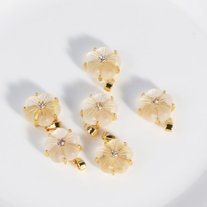 Stainless steel necklace with six white shell flower pendants and gold plated finish