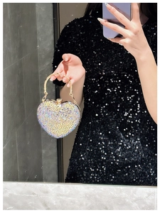 Macro detail of luxury heart evening bag with glittering AB crystals and gold handle