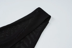 Close-up of black mesh fabric texture and transparent netting on a sexy v-neck dress