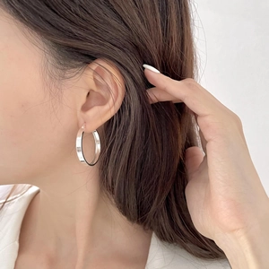 Minimalist S925 sterling silver hoop earrings with a polished finish shown on a model