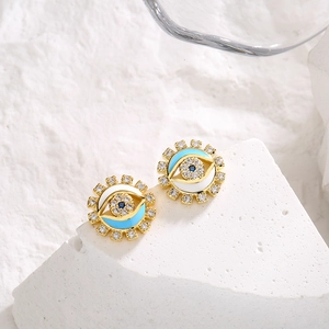 Luxury gold devil's eye stud earrings with blue enamel and sparkling crystals