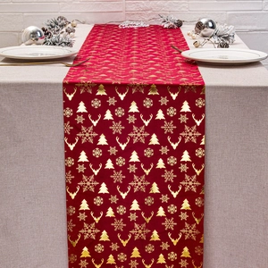 Festive red velvet table runner with gold reindeer and snowflake patterns for Christmas