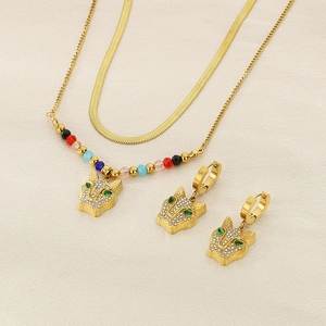 Detailed set of double-layered gold snake chain with leopard pendant and matching earrings