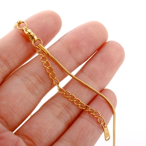 Macro detail of 18k gold plated stainless steel chain with lobster clasp and S.STEEL tag