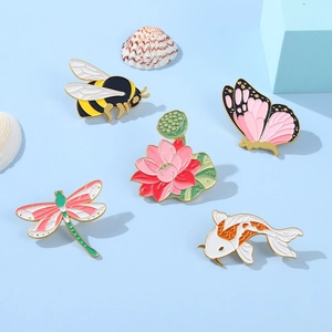 Set of 5 enamel pins featuring bee, butterfly, lotus and koi fish with gold metal finish