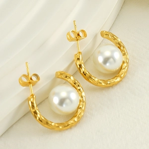 Chic C-shaped gold-plated stainless steel earrings featuring large white pearls on marble