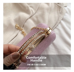 Detail of lavender glitter evening clutch with rhinestone borders and gold handle