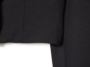 Detailed macro shot of high-quality black twill fabric and reinforced double-needle stitching