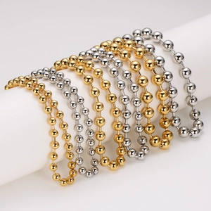 Minimalist stainless steel bead chain necklaces in gold and silver finishes on a white roll