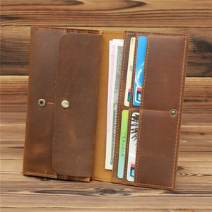 Close-up of vintage brown crazy horse leather wallet showing card slots and cash pocket