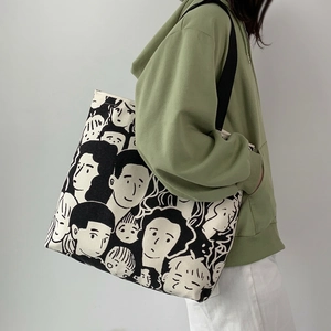 Large canvas tote bag with hand-drawn portrait print and wide black shoulder strap