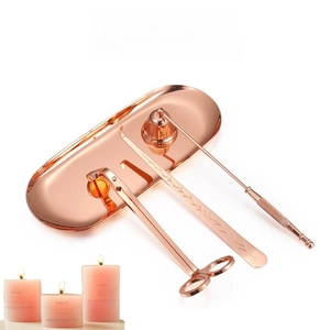 Detailed macro view of rose gold candle care set with floral textured storage tray