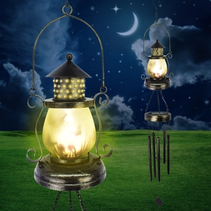 Close-up of bronze metal solar moon wind chime with glowing frosted glass and star motifs