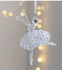 Detailed view of a transparent acrylic ballerina Christmas ornament with light-refracting facets