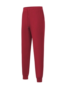 Detail of red waffle knit joggers featuring adjustable drawstring and elasticated cuffs