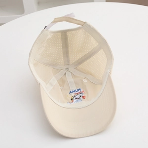 Detail view of the breathable mesh crown and colorful dinosaur embroidery inside the cap