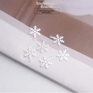 Detailed view of six hollow S925 sterling silver snowflake charms for DIY jewelry making