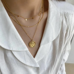 French style double-layered gold necklace with rose pendant and geometric charms