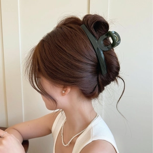Deep forest green oversized hair claw clip for elegant women styling on dark hair