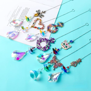 Detail of crystal suncatchers with metal chains and multi-faceted prism pendants