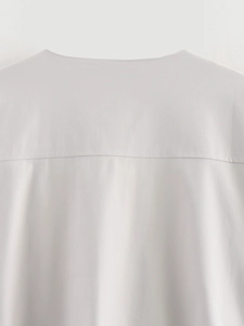Detailed macro view showing the fine stitching and seam work on the back shoulder of the jacket