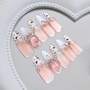 French gradient press-on nails with pink glitter, 3D heart gems and pearl decorations